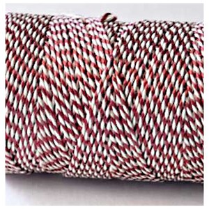 May include: A spool of white and red striped twine.