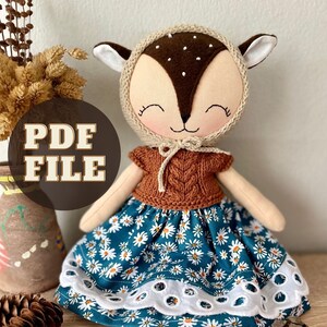 May include: PDF pattern for a handmade deer doll wearing a brown knitted sweater and a teal floral skirt with white lace trim. The doll has a brown felt nose and white felt eyes.
