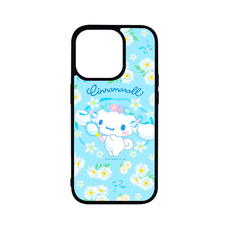 May include: A black-framed phone case featuring a light blue background with white daisies and a cartoon character. The character, wearing a flower crown, is labeled "Cinnamoroll". The case has cutouts for the camera and buttons.