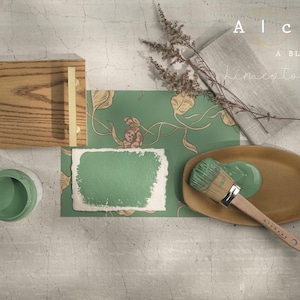 May include: An overhead shot features a paint color palette with the text "Alchemy by Fusion, A Blend of Limestone & Chalk." The palette includes a wooden block, green paint, a brush, and decorative paper.