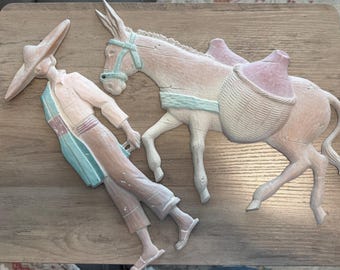 Vintage, pastel-painted metal wall art plaques, often identified as Sexton or Homco Southwestern Folk Art decor