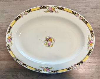 Edwin M. Knowles oval serving platter in the 402E1 pattern, featuring a distinctive yellow border with floral motifs