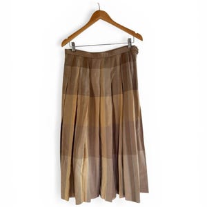 May include: A white ceramic mug with a black handle and the text "But First, Coffee" in a black, bold font. The mug is on a white surface.