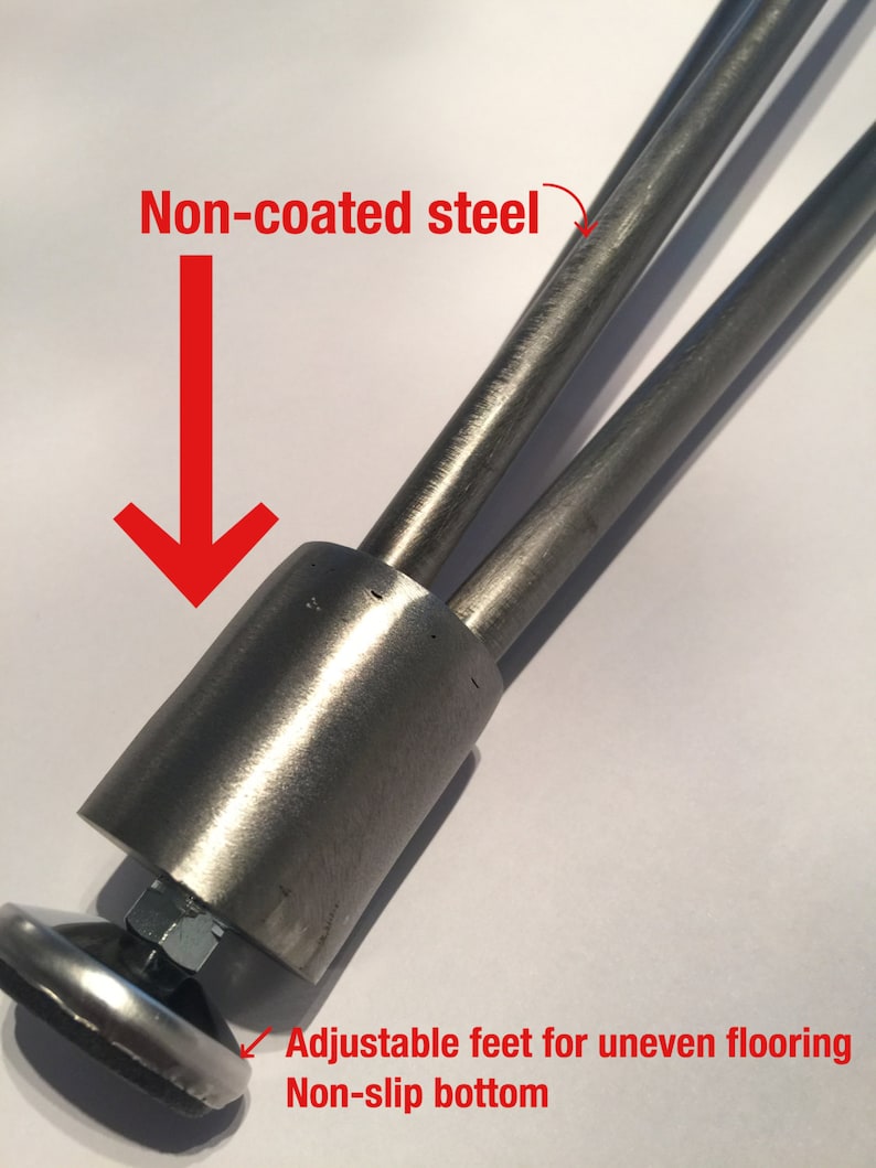 May include: Close-up of a set of three non-coated steel legs for furniture. The legs have adjustable feet with a non-slip bottom.