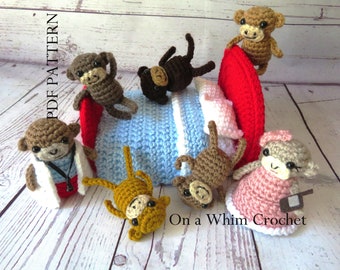 May include: A crocheted bed with a red headboard and blue and white bedding. Seven crocheted monkeys are around the bed, including one wearing a doctor's coat and another wearing a pink dress. The text "On a Whims Crochet" is on the bottom right of the image.