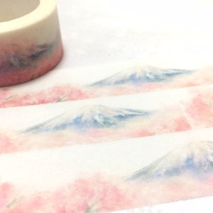 K&ouml;nnte beinhalten: Eine Rolle Washi-Tape mit einem Aquarell-Design von Mount Fuji und Kirschbl&uuml;ten. Das Band ist wei&szlig; mit einem hellrosa und blauen Aquarell-Design.