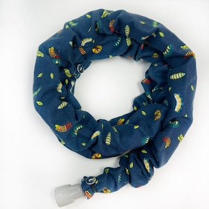 May include: A blue fabric tube with a pattern of colorful caterpillars and leaves. The tube has a gray plastic end cap.