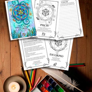 Puede incluir: Una superficie de madera muestra acuarelas, lápices de colores y una vela encendida. Varias páginas abiertas de un diario presentan ilustraciones y texto sobre el zodíaco. Una pluma descansa cerca.
