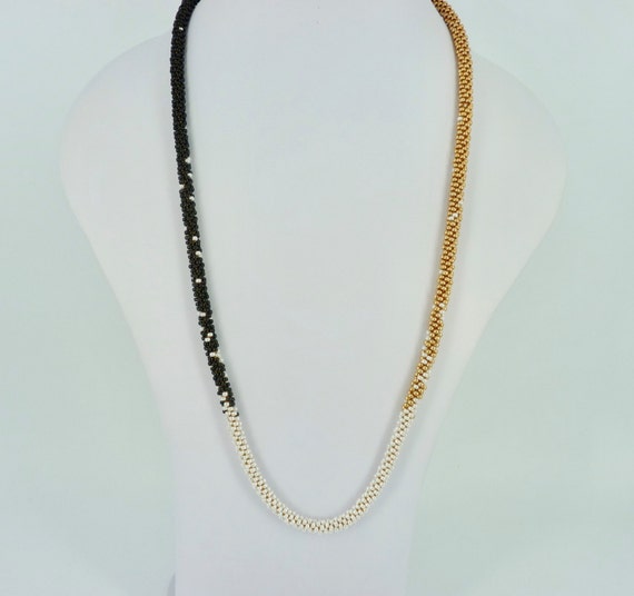 Long kumihimo necklace in gold, black en pearl white