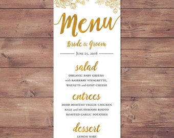 May include: A wedding menu with gold lettering on a white background. The menu includes salad, entrees, and dessert options. The text reads: "Menu", "Bride & Groom", "June 25, 2016", "salad", "Organic baby greens with raspberry vinaigrette, walnuts and goat cheese", "entrees", "Herb roasted veggie chicken, kale and mushroom risotto, roasted garlic potatoes", "dessert", "Lemon bars, wedding cake".