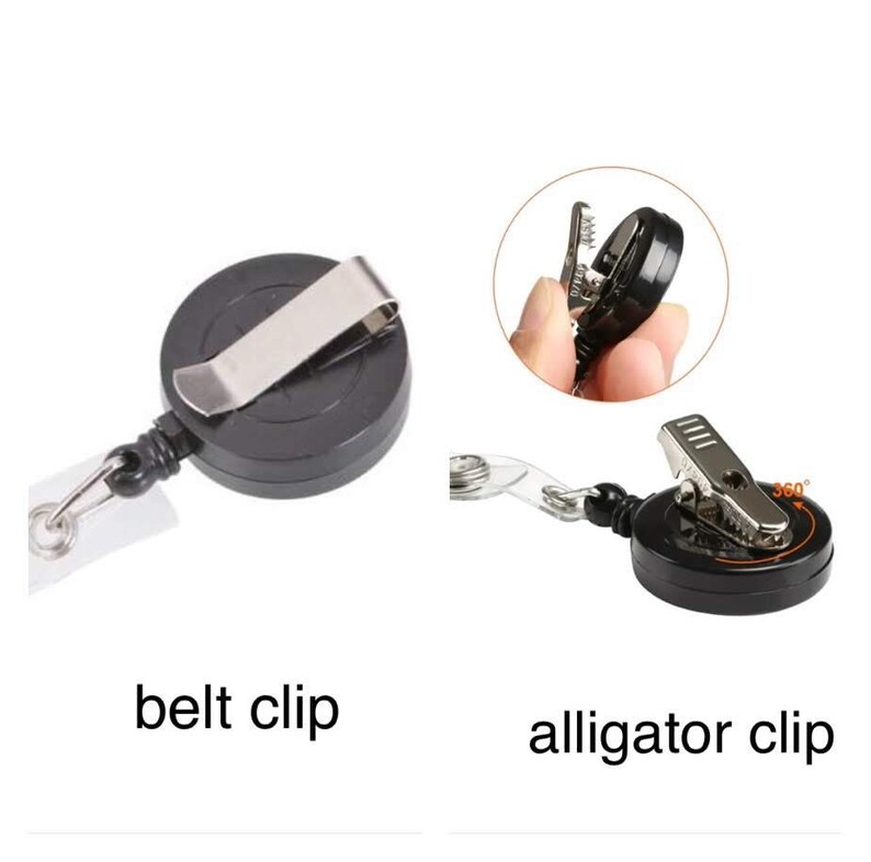 May include: Black retractable badge holders with a silver metal belt clip and alligator clip. The badge holders have a clear plastic strap and a 360-degree rotating clip. The text "belt clip" and "alligator clip" are below the badge holders.