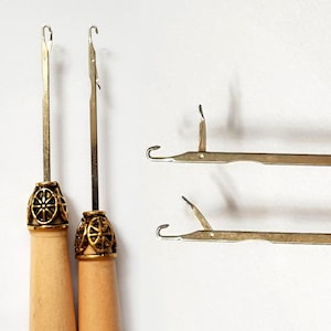 May include: Two wooden handled crochet hooks with gold metal tips and two metal crochet hooks with a silver finish.