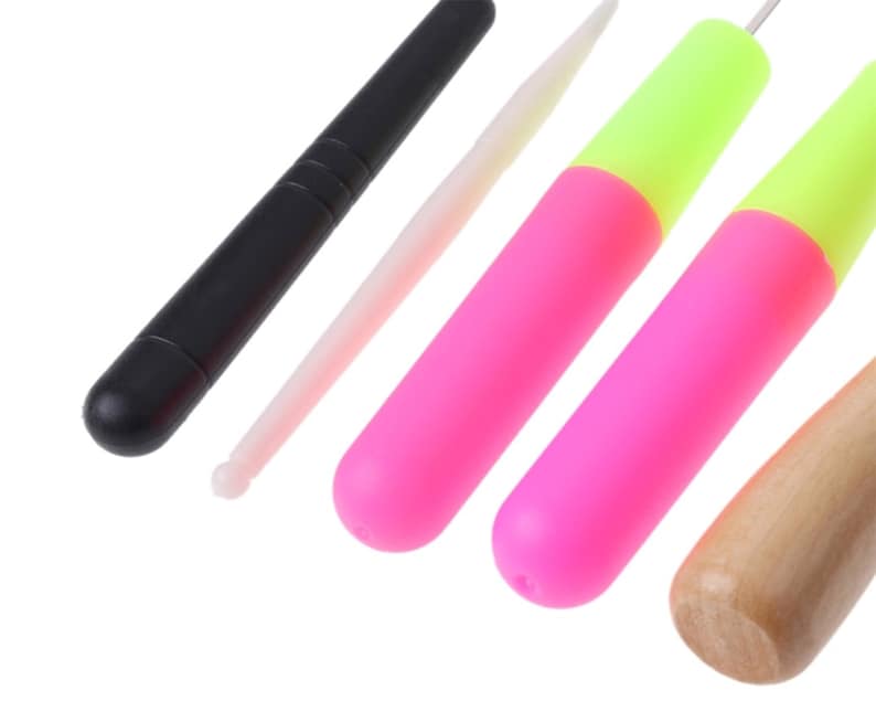 May include: A set of five tools for crafting, including a black plastic tool, a white plastic tool, two pink and yellow plastic tools, and a wooden tool.