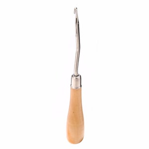 May include: A wooden handled crochet hook with a metal hook.