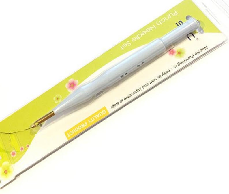 May include: A white punch needle with a gold tip, packaged on a yellow and green background. The packaging reads "Punch Needle Set" and "Needle Punching is...easy to start and impossible to stop! QUALITY PRODUCT".