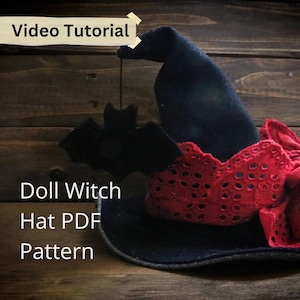 May include: A black doll witch hat with a red lace trim and a black bat decoration. The hat has a pointed crown and a wide brim. Text on the image reads "Video Tutorial" and "Doll Witch Hat PDF Pattern".