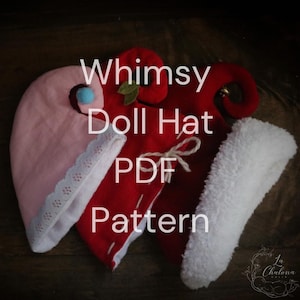 May include: Three doll hats in pink, red, and white, with the text "Whimsy Doll Hat PDF Pattern." The pink hat has a lace trim and a blue pom-pom. The red hat has a leaf and a bell. The white hat has a fluffy texture.