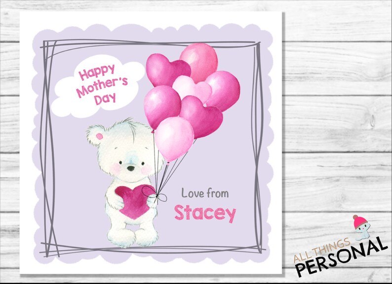 May include: A white teddy bear holding a pink heart, surrounded by pink and white heart-shaped balloons. The card reads "Happy Mother's Day" and "Love from Stacey".