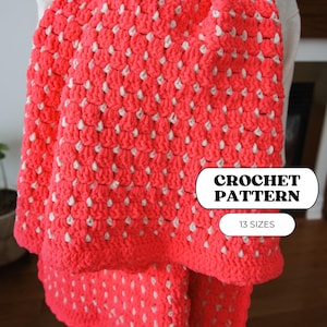 May include: A vibrant coral-colored crochet blanket with a textured pattern of white dots. The blanket is folded, showcasing its thick, cozy appearance. Text on the image reads "CROCHET PATTERN" and "13 SIZES".