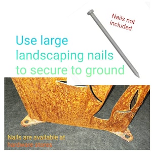 May include: A rusty metal garden decoration with a leaf design. The decoration has two metal tabs on the bottom to secure it to the ground. The text "Use large landscaping nails to secure to ground" is written above the decoration. The text "Nails not included" is written above a close-up of a large nail.