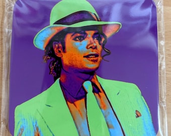 May include: Square coaster featuring a vibrant pop art style image of a person wearing a green suit and hat against a purple background. The image has orange, blue, and green tones, creating a striking visual effect. The coaster is likely made of a durable material.