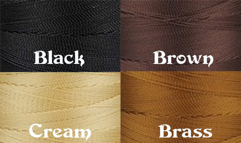 May include: Four spools of thread in different colors: black, brown, cream, and brass.