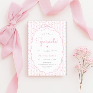 Op de afbeelding: Een baby sprinkle uitnodiging in roze en wit. De uitnodiging heeft de tekst "It's a Baby Sprinkle!" in een decoratief lettertype, met evenementdetails. Roze lint en bloemen zijn rond de uitnodiging gerangschikt.