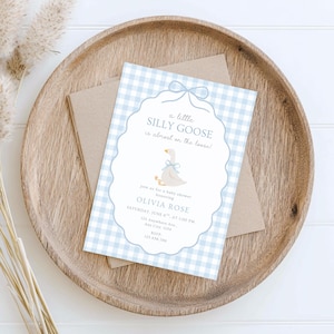 Puede incluir: Una invitaci&oacute;n a un baby shower con un borde de patr&oacute;n de cuadros vichy azul claro y una ilustraci&oacute;n de un ganso de dibujos animados. El texto dice "a little SILLY GOOSE is almost on the loose!" e incluye detalles del evento.