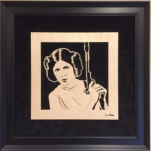 Carrie Fisher as Princess Leia Blaster at the Ready portrait is hand cut using a scroll saw and mounted to a black suede mat and framed image 5