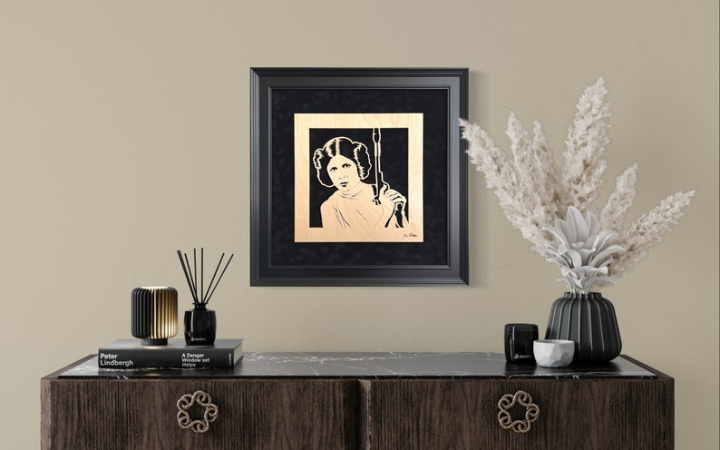 Carrie Fisher as Princess Leia Blaster at the Ready portrait is hand cut using a scroll saw and mounted to a black suede mat and framed image 1