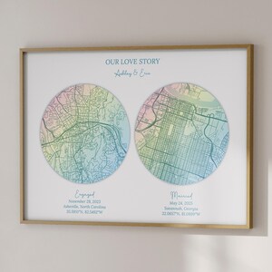 May include: A framed print featuring two circular map illustrations with pastel colors. The text "OUR LOVE STORY" is above the maps. The print includes the text "Engaged" and "Married" with dates and locations. Additional text on the right side says "LESS THAN 24 HOURS".