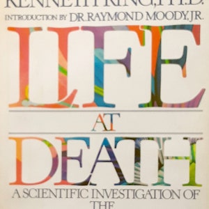 May include: Book cover with the title "Life at Death: A Scientific Investigation of the Near-Death Experience" by Kenneth Ring, Ph.D. with an introduction by Dr. Raymond Moody, Jr. The title is in colorful, stylized lettering.
