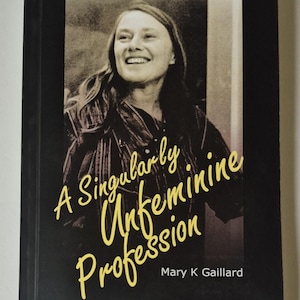 May include: A book cover with a sepia-toned portrait of a smiling woman. The title reads "One Woman's Journey in Physics" above the image. Below the image, in yellow script, is the title "A Singularly Unfeminine Profession" by Mary K Gaillard.