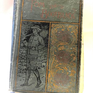 May include: Antique book titled "Tom the Bootblack" with a dark teal cover. The cover features a black and white illustration of a man carrying a bundle and a walking stick. The title is in red lettering.
