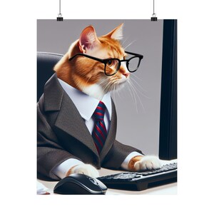 May include: An orange and white cat wearing black-rimmed glasses, a dark gray suit jacket, a white collared shirt, and a red and blue striped necktie. The cat is positioned at a desk with a black computer keyboard and a black computer mouse.