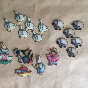 May include: A set of felt animal figurines, including a bunny, a cow, a farmer, a sheep, and a goose. The figurines are all hand-painted and have a whimsical, vintage style.