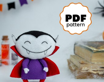 May include: A PDF pattern for a cute, felt vampire toy. The toy is wearing a red cape and has a purple shirt. The pattern is available for download.