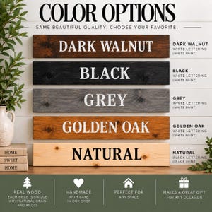 May include: A color options chart for wooden signs featuring five horizontal planks in dark walnut, black, grey, golden oak, and natural finishes. Each plank displays its color name in bold lettering, with white text on darker boards and black text on the natural board.