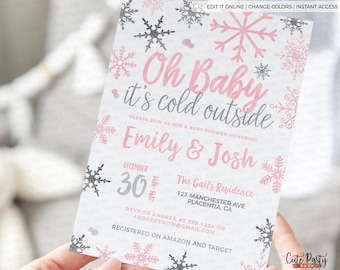 May include: A pink and gray baby shower invitation with snowflakes and the text "Oh Baby it's cold outside". The invitation is for Emily & Josh and is scheduled for December 30th. The event will be held at The Gails Residence, 123 Manchester Ave, Placentia, CA. RSVP to Andrea at 555.1234 or andreasmith@gmail.com. The couple is registered on Amazon and Target.