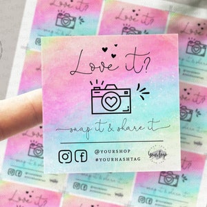 May include: A set of 10 printable photo booth props featuring a watercolor background with a rainbow gradient. The props feature a camera icon, hearts, and the text "Love it? Snap it & share it".
