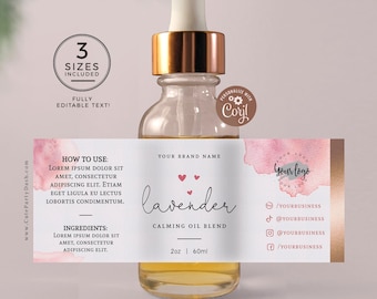 May include: A clear glass bottle with a gold lid and a pink and white label. The label has a watercolor design and the text "lavender calming oil blend" and "2 oz | 60 ml".