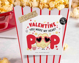 May include: A white and red striped popcorn box with a Valentine's Day themed card attached. The card features a cartoon popcorn kernel with sunglasses and the text "Valentine: You Make My Heart Pop".