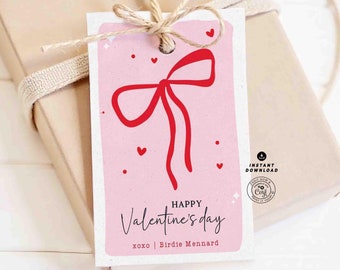 May include: Pink printable gift tag with a red bow and the text "Happy Valentine's Day" with the name "Birdie Mennard" and the text "xoxo".