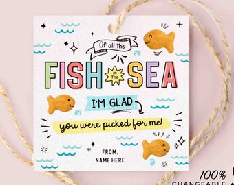 May include: A colorful printable tag with a goldfish cracker and the text "Of all the fish in the sea, I'm glad you were picked for me!"  The tag is decorated with waves, stars, and a sun. The text "From: Name Here" is at the bottom of the tag.