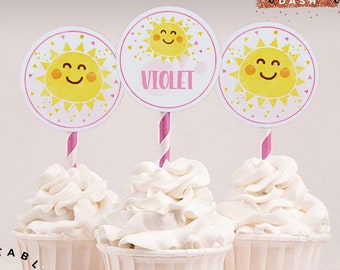 May include: Three cupcake toppers featuring a yellow sun with a smiling face and pink accents. The toppers are on white cupcakes with white frosting. The text "VIOLET" is on one of the toppers. The text "Cute Party Dash" is at the top of the image. The text "Editable text feature" is at the bottom left of the image. The text "Instant Download Easy as 1-2-3. Purchase, Download Instantly & Print" is at the bottom right of the image.