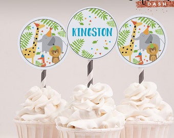 May include: Three cupcake toppers with a jungle animal theme. The toppers feature a giraffe, elephant, lion, and fox. The center topper has the name "KINGSTON" in blue text. The text "Cute Party Dash" is in the top right corner of the image. The text "editable text feature" and "INSTANT Download" are in the bottom of the image.