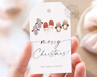 May include: White gift tag with a red and white Santa Claus, reindeer, and snowman illustration. The tag says "merry Christmas!" and "The Gails Family".