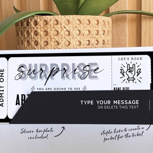 May include: A black and white printable ticket template with the text "Surprise! You are going to see..." and "Let's Rock!" with a rock and roll hand symbol. The ticket has a black sleeve with the text "Type your message or delete this text".