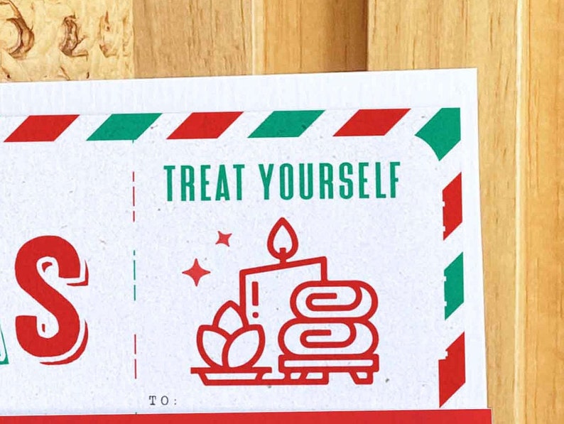May include: A white card with red and green stripes at the top. The card says "TREAT YOURSELF" in green letters. There is a red and white illustration of a candle, a plant, and towels on a plate. The card also says "TO:" at the bottom.