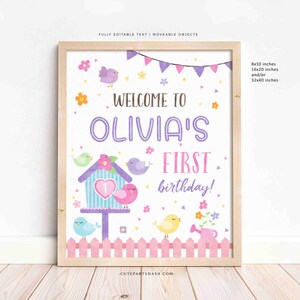 May include: A printable welcome sign for a first birthday party. The sign features a pink and purple color scheme with a birdhouse, birds, flowers, and a fence. The text on the sign reads "Welcome to Olivia's First Birthday!"